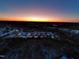 Beautiful sunrise aerial view of charming neighborhood featuring scenic pond and picturesque landscape with snow covered ground at 144 Elk Stone Trl, Garner, NC 27529