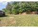 Spacious, well-maintained backyard with a wooden fence and mature trees at 144 Elk Stone Trl, Garner, NC 27529