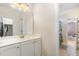 Bright bathroom vanity with large mirror and view into the toilet and shower area at 144 Elk Stone Trl, Garner, NC 27529