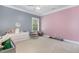Spacious bedroom with carpet flooring and two-tone grey and pink painted walls at 144 Elk Stone Trl, Garner, NC 27529