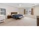 Spacious main bedroom with tray ceiling, ample natural light, and a comfortable lounge area at 144 Elk Stone Trl, Garner, NC 27529