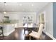 Bright dining area featuring hardwood floors, a dining table, and a seamless transition to the modern kitchen at 144 Elk Stone Trl, Garner, NC 27529