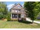 Charming two-story home featuring brick and stone facade, covered porch, well-maintained lawn and mature trees at 144 Elk Stone Trl, Garner, NC 27529