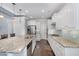 Spacious kitchen with stainless steel appliances, granite countertops, and white cabinets with dark hardwood floors at 144 Elk Stone Trl, Garner, NC 27529