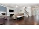 Inviting living room boasts hardwood floors, a ceiling fan, fireplace, and staircase leading to upper level at 144 Elk Stone Trl, Garner, NC 27529