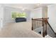 Upstairs loft featuring plush carpet, neutral paint, and a comfortable couch at 144 Elk Stone Trl, Garner, NC 27529
