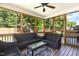 Outdoor patio with wood paneled ceiling, wicker furniture, and view of backyard play set at 144 Elk Stone Trl, Garner, NC 27529
