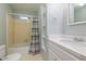 This bathroom has a shower with a tub, patterned shower curtain and a white vanity with solid surface counter at 1506 Ephesus Church Rd, Chapel Hill, NC 27517