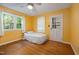 Bright bedroom featuring hardwood floors, a ceiling fan, and a door to the exterior at 1506 Ephesus Church Rd, Chapel Hill, NC 27517