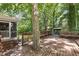 Spacious wooden deck featuring a built-in seating area and a mature tree growing through it at 1506 Ephesus Church Rd, Chapel Hill, NC 27517
