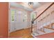 Bright foyer featuring hardwood floors, a staircase, and a charming front door entrance at 1506 Ephesus Church Rd, Chapel Hill, NC 27517