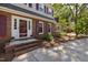 Inviting front entrance with brick steps and decorative flower pots, offering curb appeal at 1506 Ephesus Church Rd, Chapel Hill, NC 27517