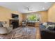 Inviting living room featuring a brick fireplace, hardwood floors, and a large window at 1506 Ephesus Church Rd, Chapel Hill, NC 27517