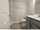 This bathroom features a vanity with gray cabinets, toilet, and nice finishes at 1590 Pecan Drive # 45, Nashville, NC 27856