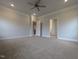 Large bedroom with neutral carpet, ceiling fan, crown molding and access to the ensuite bathroom at 1590 Pecan Drive # 45, Nashville, NC 27856