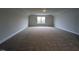 Expansive bonus room with a large window and plush carpeting at 1590 Pecan Drive # 45, Nashville, NC 27856