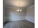 Elegant dining room featuring decorative molding, modern chandelier, and hardwood floors at 1590 Pecan Drive # 45, Nashville, NC 27856