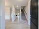 Bright entryway featuring modern flooring, staircase, and open floor plan leading to living area at 1590 Pecan Drive # 45, Nashville, NC 27856
