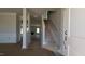 View of the home's foyer, featuring stairs and molding, leading to the living room and other living spaces at 1590 Pecan Drive # 45, Nashville, NC 27856