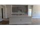 Modern kitchen island with white countertops, providing ample space for food preparation and seating at 1590 Pecan Drive # 45, Nashville, NC 27856