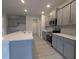 Modern kitchen featuring gray cabinets, stainless steel appliances, and a large center island at 1590 Pecan Drive # 45, Nashville, NC 27856