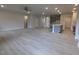 Bright open-concept living room showing light hardwood flooring, neutral walls and kitchen with island at 1590 Pecan Drive # 45, Nashville, NC 27856