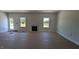 Open living area with fireplace, large windows, and exterior door to the backyard at 1590 Pecan Drive # 45, Nashville, NC 27856