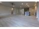 Bright open-concept living room showing light hardwood flooring, neutral walls, stairs and kitchen with island at 1590 Pecan Drive # 45, Nashville, NC 27856
