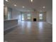 Spacious open-concept living room with light hardwood floors, neutral walls, fireplace and a ceiling fan at 1590 Pecan Drive # 45, Nashville, NC 27856