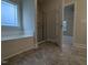 Ensuite bathroom features a garden tub, glass shower, tile flooring and access to the bedroom at 1590 Pecan Drive # 45, Nashville, NC 27856