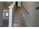 Stairway with wood handrail ready for the new homeowner, leading to the upper level of the home at 1590 Pecan Drive # 45, Nashville, NC 27856