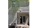 Backyard exterior showcasing sliding glass doors, AC unit, siding, and outdoor lighting at 1610 Oxleymare Dr, Raleigh, NC 27610