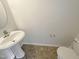 Neat bathroom with pedestal sink and toilet, offering a clean and functional space at 1610 Oxleymare Dr, Raleigh, NC 27610