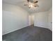 Inviting bedroom with neutral color palette, plush carpet, ceiling fan, and ensuite access at 1610 Oxleymare Dr, Raleigh, NC 27610
