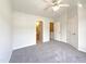 Spacious bedroom featuring neutral tones, a ceiling fan, and convenient access to the ensuite bathroom at 1610 Oxleymare Dr, Raleigh, NC 27610