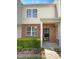 Inviting townhome entrance with brick facade, well-kept landscaping, and a bright, welcoming exterior at 1610 Oxleymare Dr, Raleigh, NC 27610