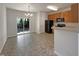 Open kitchen and dining area features wood cabinets, black appliances, and a sliding door to the outside at 1610 Oxleymare Dr, Raleigh, NC 27610