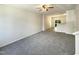 Spacious living room features neutral carpeting and open access to the adjacent kitchen and dining area at 1610 Oxleymare Dr, Raleigh, NC 27610