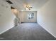 Bright living room with neutral carpet, large window and a staircase leading to the upper level at 1610 Oxleymare Dr, Raleigh, NC 27610