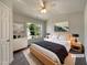 Virtual staging enhances this main bedroom, showcasing ample natural light and comfortable living space at 1610 Oxleymare Dr, Raleigh, NC 27610
