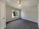 Bright main bedroom with a large window offering natural light and neutral carpeting throughout at 1610 Oxleymare Dr, Raleigh, NC 27610