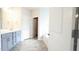 Bright bathroom with double sink vanity, soaking tub, and separate door to the walk in closet space at 1635 Pecan Drive # 26, Nashville, NC 27856