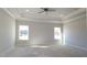 An expansive bedroom features a ceiling fan, recessed lighting, and two windows at 1635 Pecan Drive # 26, Nashville, NC 27856