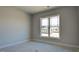 Empty bedroom with light gray walls, white trim, and a large window at 1635 Pecan Drive # 26, Nashville, NC 27856