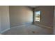 Bedroom with gray walls, base trim, and window at 1635 Pecan Drive # 26, Nashville, NC 27856