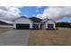 New construction home with black accents, a black two car garage, and manicured yard at 1635 Pecan Drive # 26, Nashville, NC 27856