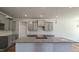 Bright kitchen features gray cabinets, granite countertops, and stainless steel sink at 1635 Pecan Drive # 26, Nashville, NC 27856