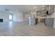 Open concept living room and kitchen with modern gray cabinets and new hardwood floors at 1635 Pecan Drive # 26, Nashville, NC 27856