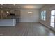 Open-concept living space with gray wood-look floors, gray cabinets, and a center island at 1635 Pecan Drive # 26, Nashville, NC 27856
