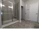 The bathroom features a glass-enclosed shower and tiled floors, plus a storage closet at 1640 Pecan Drive # 44, Nashville, NC 27856